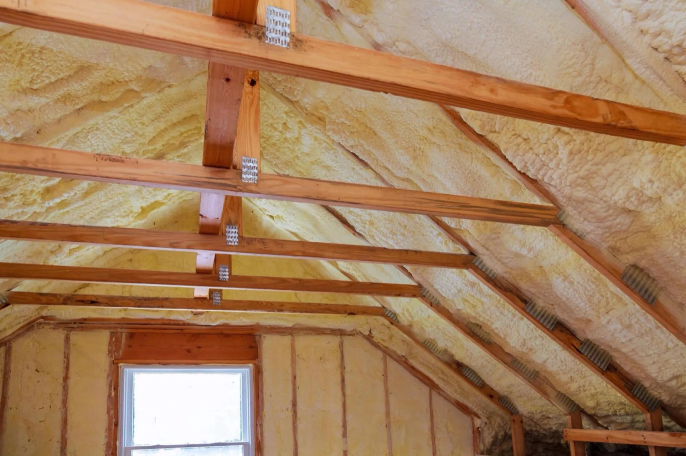 Pole barn interior with finished foam coverage